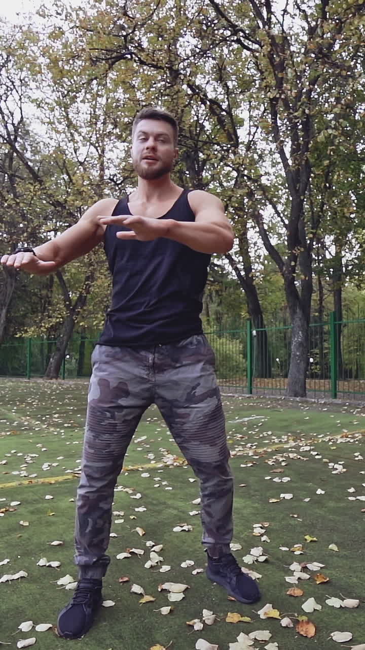 Man doing stretching exercise. Fitness man preparing for workout in the park