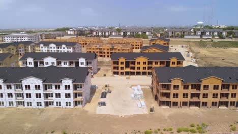 sideways aerial drone view of apartment home residential building construction site in round rock, texas, usa