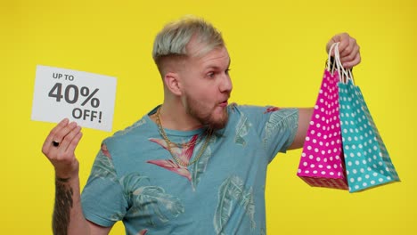 cheerful tourist man showing shopping bags and up to 40 percent off inscriptions banner black friday