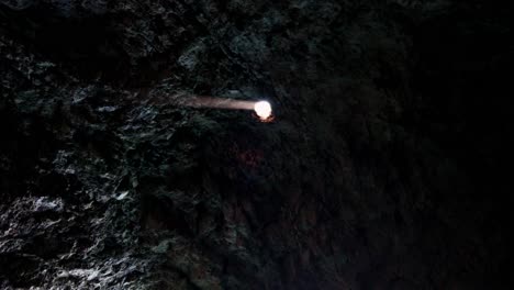 ray of sunlight entering and illuminating a cave through a hole in the ceiling, vis island, adriatic sea, croatia