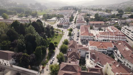 Small-town-of-Arouca-with-mountain-range-in-horizon,-aerial-drone-view