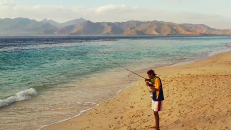 Junger-Mann,-Der-An-Einem-Exotischen-Strand-Mit-Klarem-Himmel-Und-Blauem-Wasser-Im-Exotischen-Urlaubsort-Bora-Bora-Fischt