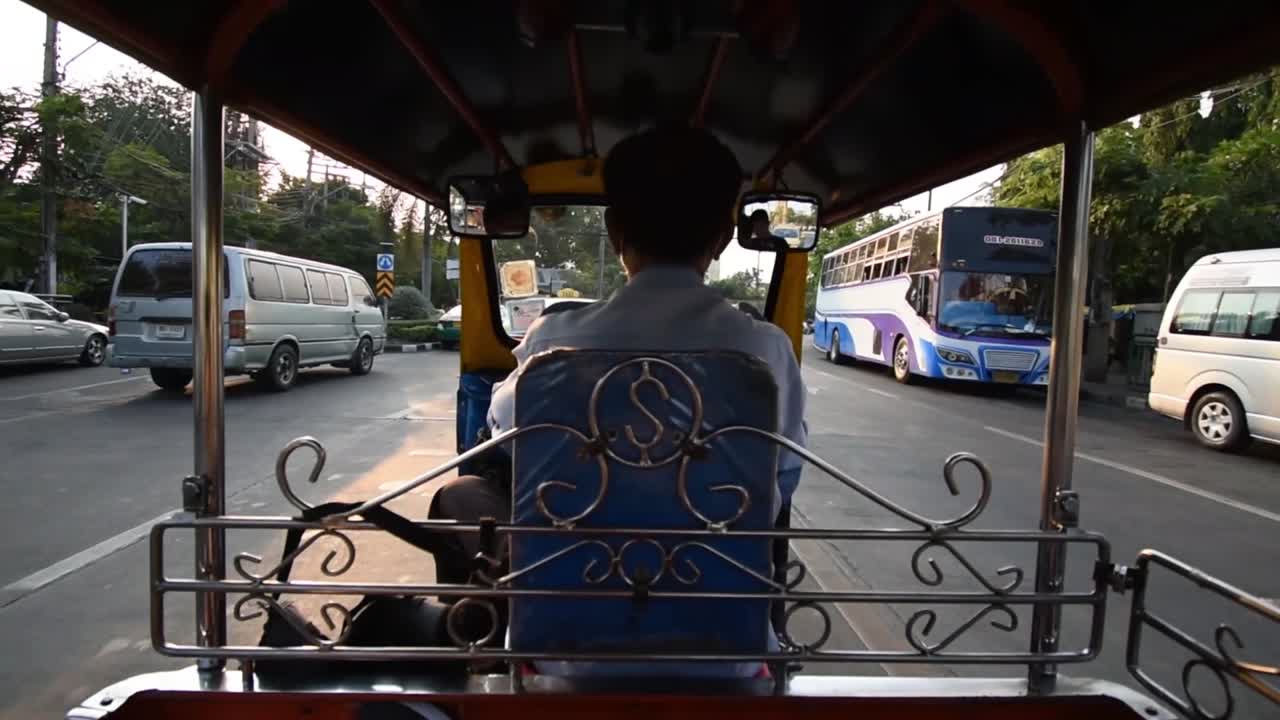 Point of view shot from back of tuk-tuk driving through Bangkok, Thailand