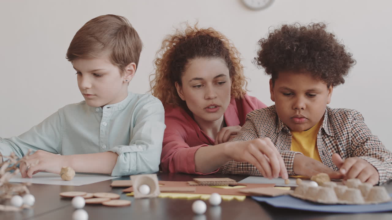 Woman Helping Children with School Project