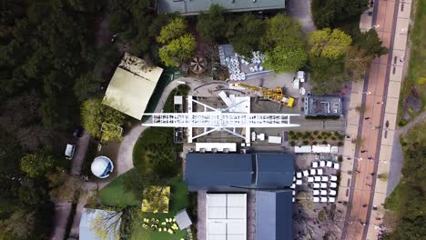 workers building ferris wheel in palanga, aerial top down view