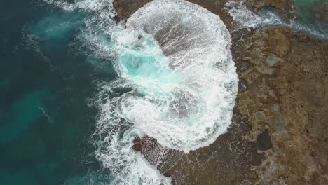 Overhead-view-of-waves-crashing-onto-rocky-shore-at-Sharks-cove-Hawaii