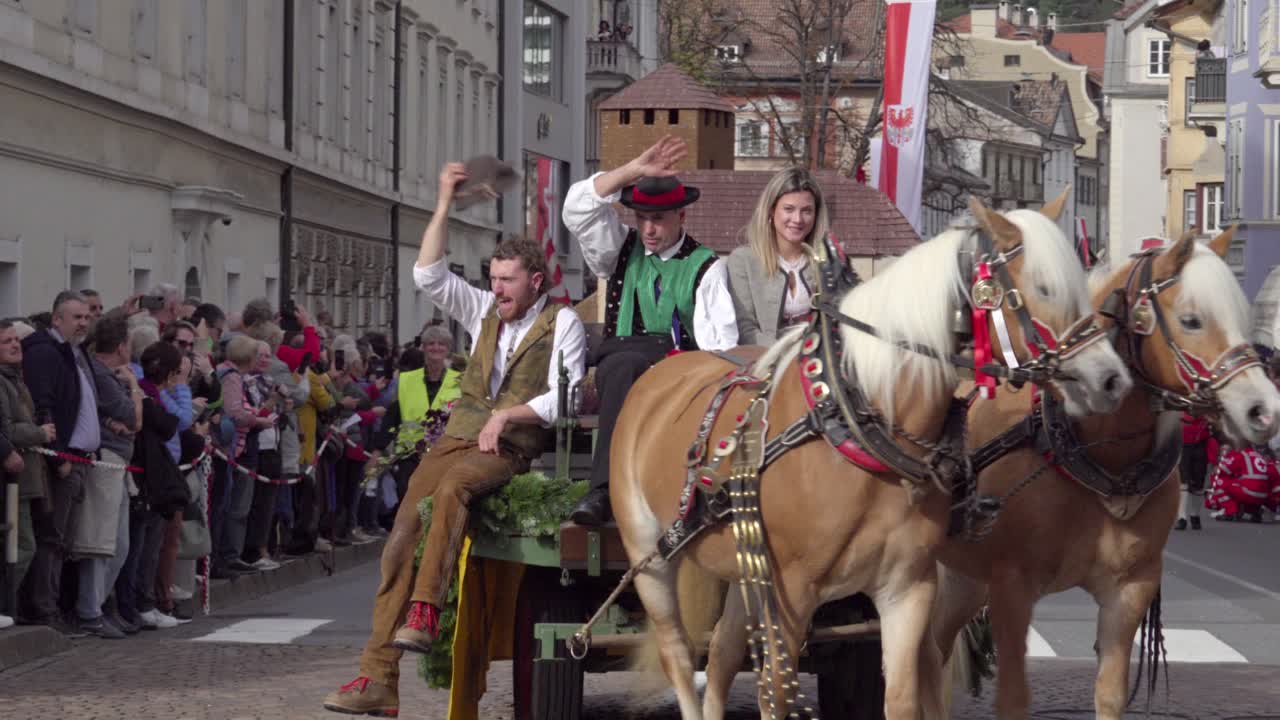 Traditional Parade with Horses and Carriages through City Streets