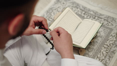 muslim man praying and reading quran