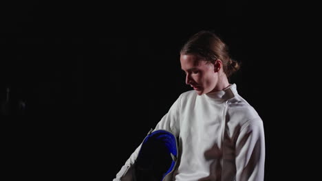 young male fencer preparing for competition