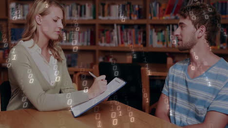 binary code animation overlaying two people discussing in school library