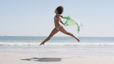 Young woman running at the beach 4k