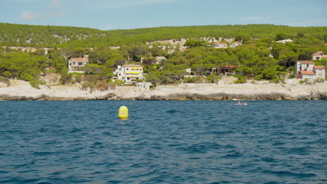 POV-From-A-Boat-Cruising-In-The-Blue-Ocean-With-Scenic-Island-On-A-Sunny-Day