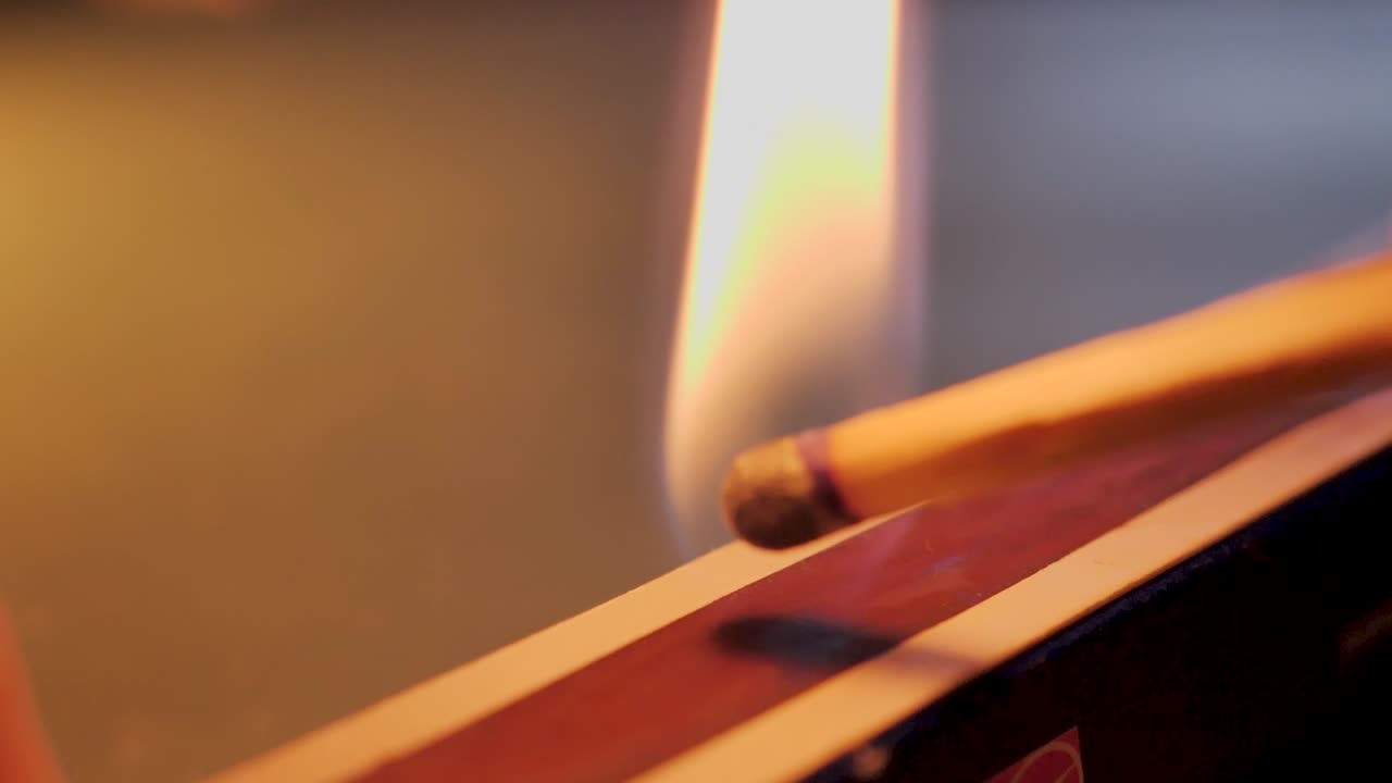 Fire matchstick. Ignition of match with smoke, selective focus. Slowmotion
