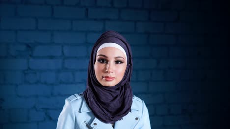 young woman wearing hijab and blue jacket
