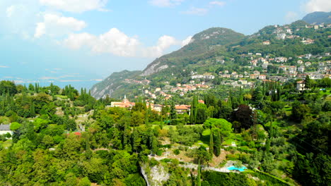 Drone-shot-of-mountains-surrounding-Lake-Como-in-Varenna,-Italy