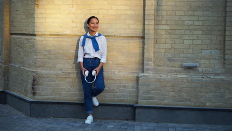 Cheerful-Woman-Listening-To-Music-With-Headphones-In-The-Street