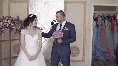 slow motion handsome fiance hugs and kisses pretty bride