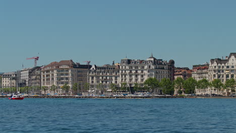 peaceful morning in geneva with the iconic jet d’eau rising from the lake, calm waters reflecting the clear sky, and the city slowly coming to life in the morning light.