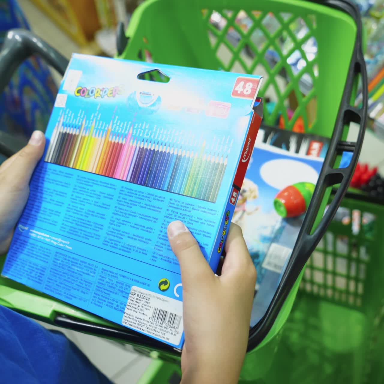 VINNITSA, UKRAINE - AUGUST 20, 2018: Boy with colour pencils in shop