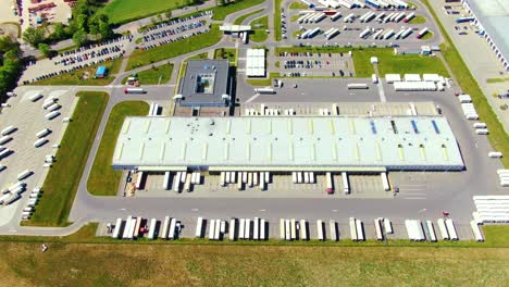 Aerial-view-of-warehouse-storages-or-industrial-factory-or-logistics-center-from-above