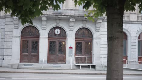 switzerland - : large swiss house with wooden gate and an old wall clock