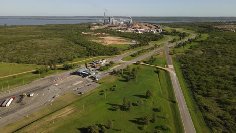 Entrance-of-paper-mill-factory-at-Fray-Bentos-and-surrounding-landscape,-Uruguay