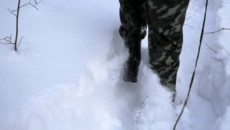 person walking through snow in a forest