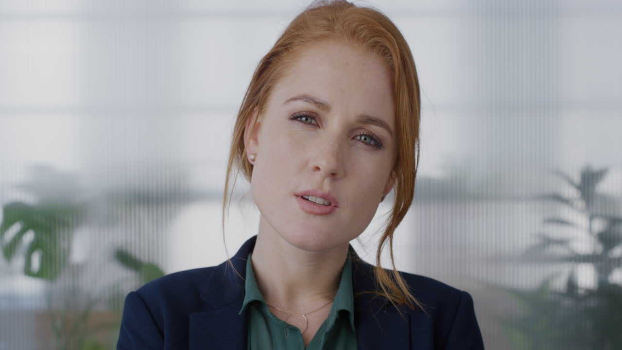 portrait young independent red head business woman smiling looking pensive enjoying professional lifestyle beautiful female entrepreneur in office