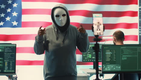 person in anonymous mask working on intelligence in a governmental hacking room