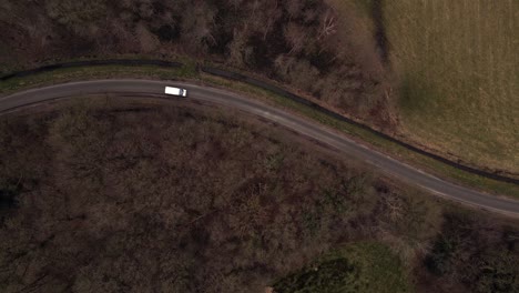 aerial view of winding country road with van