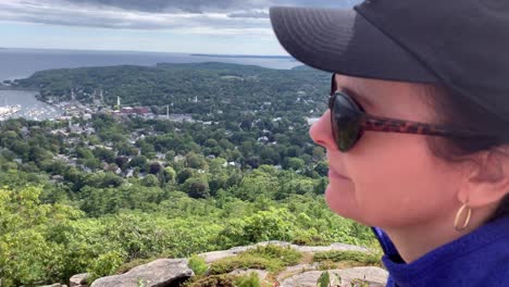 4k lady gazes down on camden maine from atop mount battie outside of camden maine