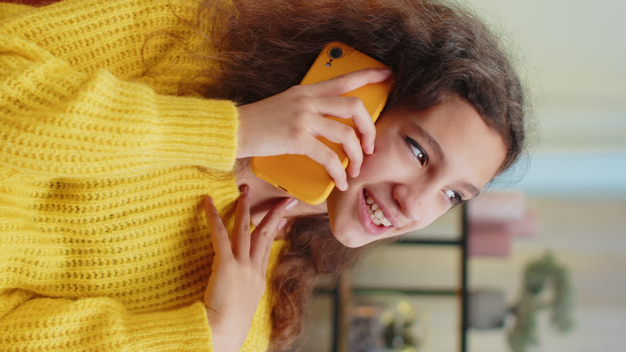 Happy surprised child girl having pleasant conversation phone call good news enjoying talking gossip