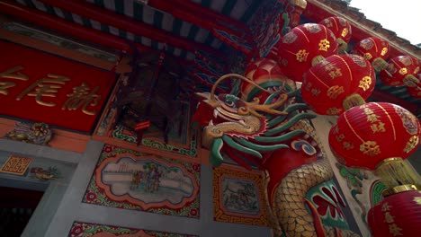 an ornate dragon carving on the facade of a chinese buddhist temple, rich in cultural symbolism, upward angle orbit