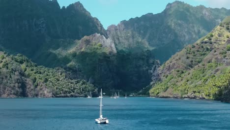 catamaran sailboat headed towards the bay of virgins fatu hiva island marquesas french polynesia in the south pacific ocean