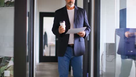 Businessman-with-coffee-cup-checking-document-4k