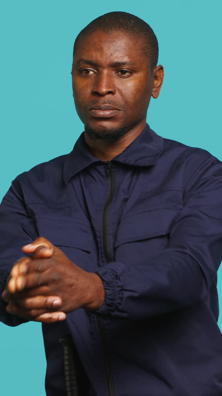 African Man in Uniform Holding Baton Against Blue Background