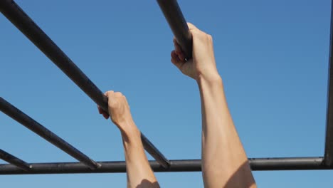 person doing pull-ups on parallel bars