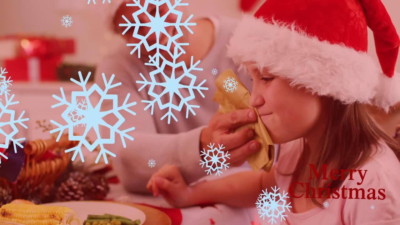 크리스마스 저녁 식사에서 아버지와 함께 백인 딸 위에 떨어지는 눈송이의 애니메이션.