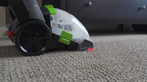 household carpet cleaning machine working to clean up dirt and stains deep from within carpet