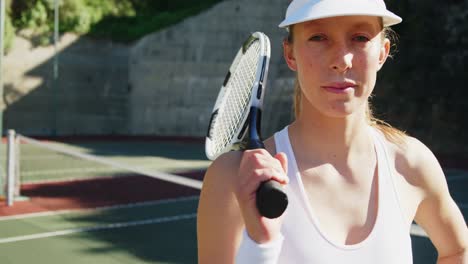 portrait of sportswoman standing with hand on hip