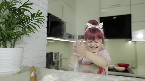 Cooking-pizza.-Little-child-playing-with-flour-gets-her-hands-dirty-in-kitchen