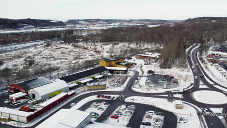 stadsmissionens second-hand stores in snowy gothenburg, busy road nearby, aerial view