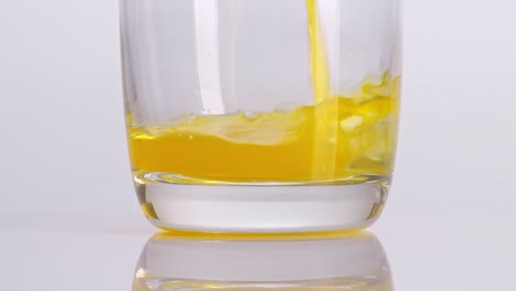 orange juice pouring into a glass