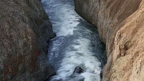 turbulent river flowing through a narrow canyon