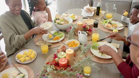 african american parents, children and grandparents celebrating at thanksgiving dinner, slow motion