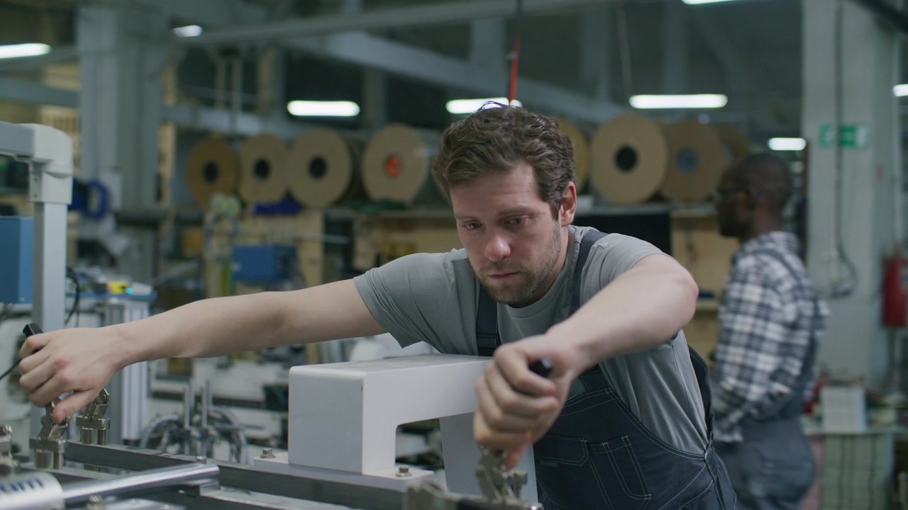 Technician Operating Industrial Machinery in Commercial Printing Factory