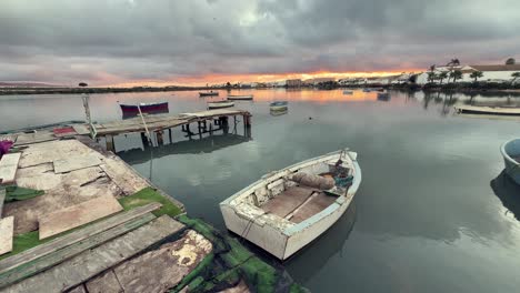 static view of of a village on the shore of a bay with fishing boats moored