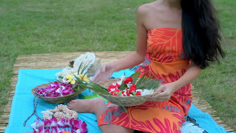 young woman arranging flower on mat in the garden 4k