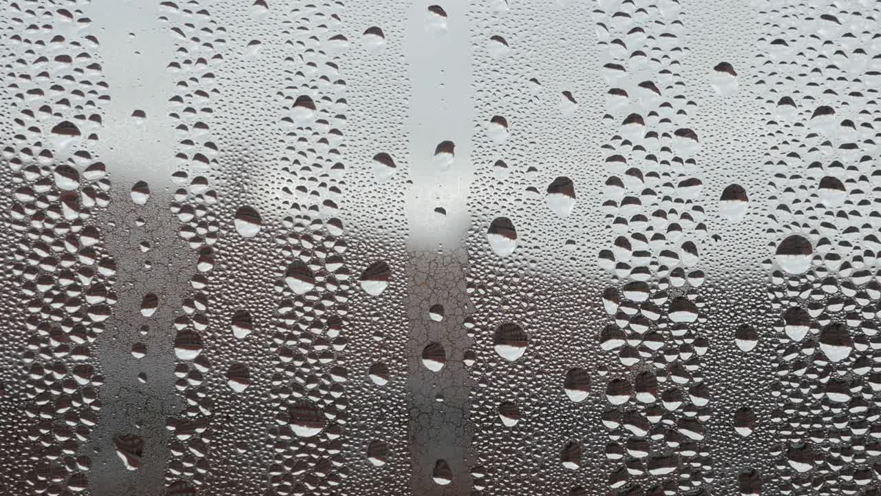 Water droplets on foggy window glass, background
