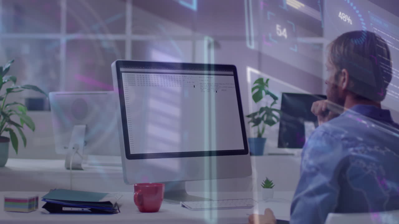 Man working at desk with digital data processing animation over computer screen